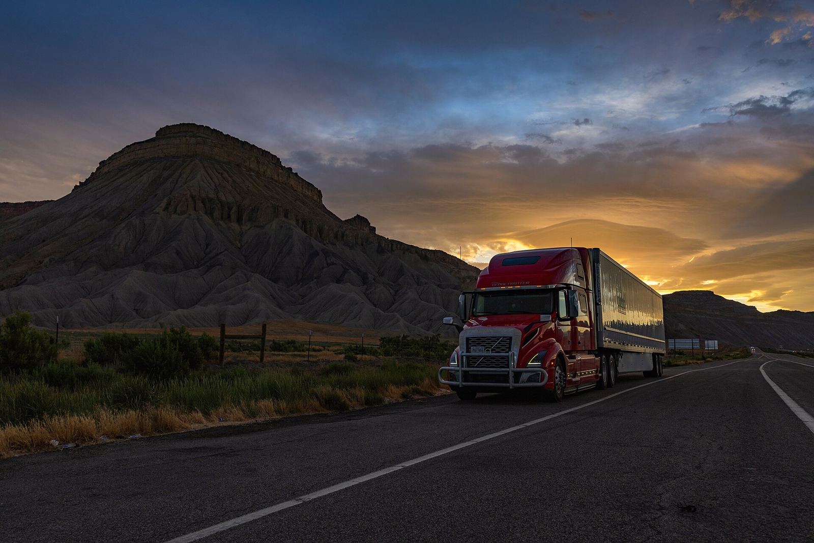 Volvo VNL 860 pulling a dry van at sunset