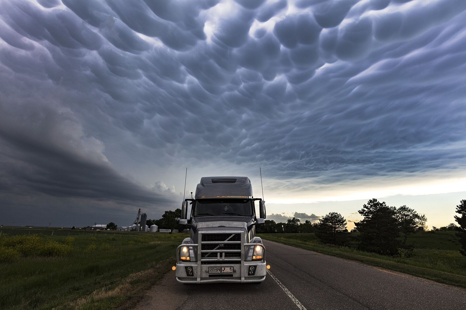 Volvo VNL on a linehaul run under a storm sky